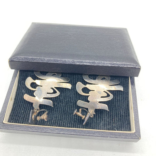 Silver earrings in a gray jewelry box on a white background