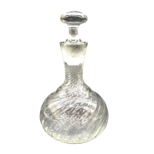 Clear glass decanter with a ribbed design on a white background
