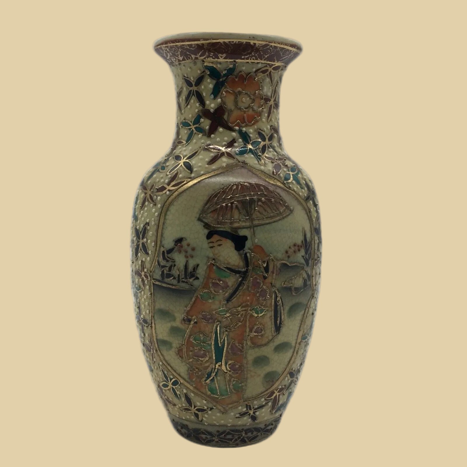 Decorative vase with intricate designs on a white background