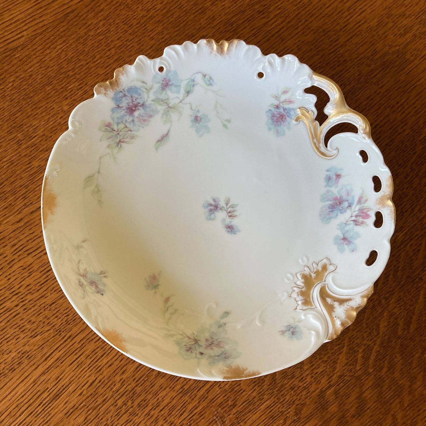Decorative ceramic bowl with floral patterns on a wooden surface