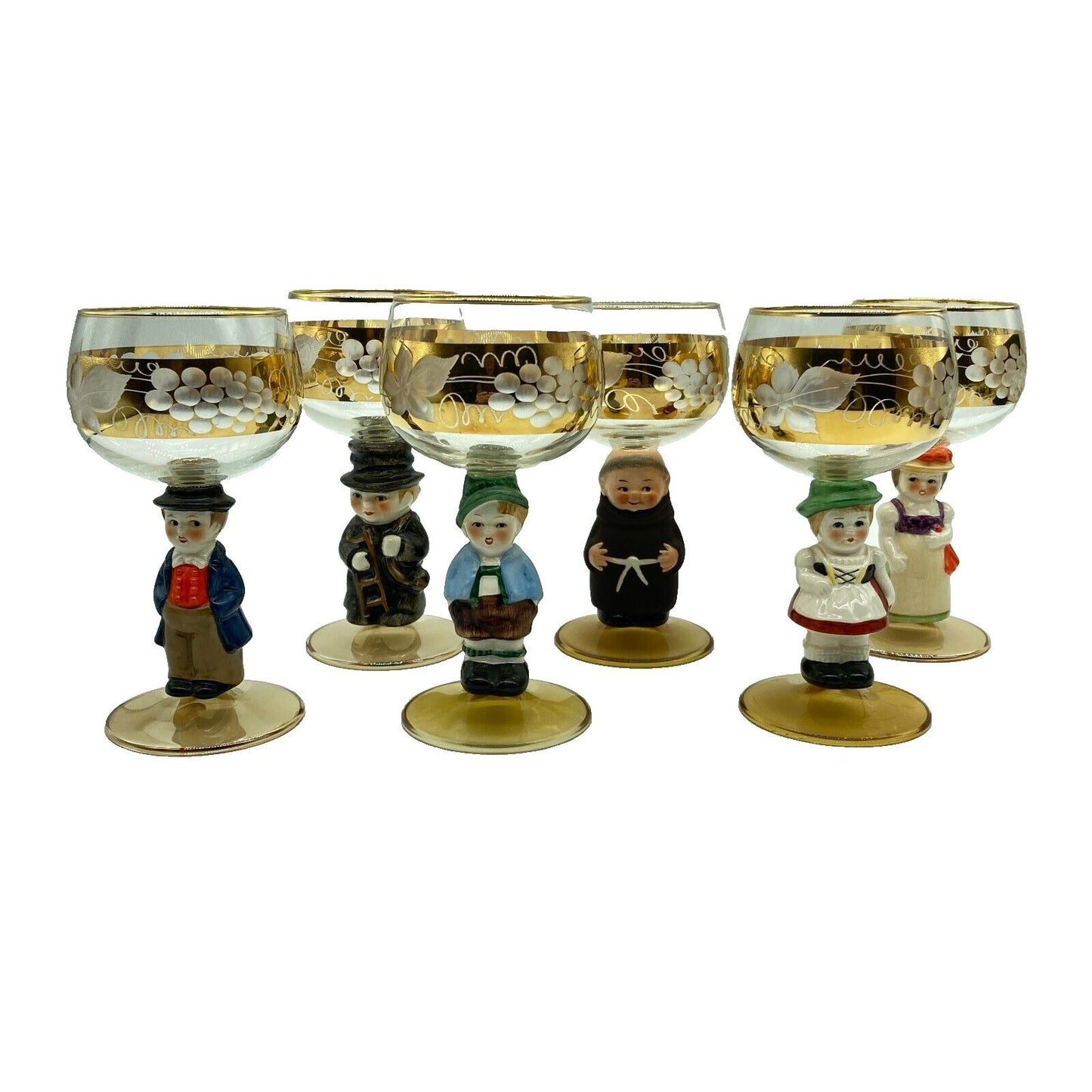 Set of six decorative glasses with figurines on a white background