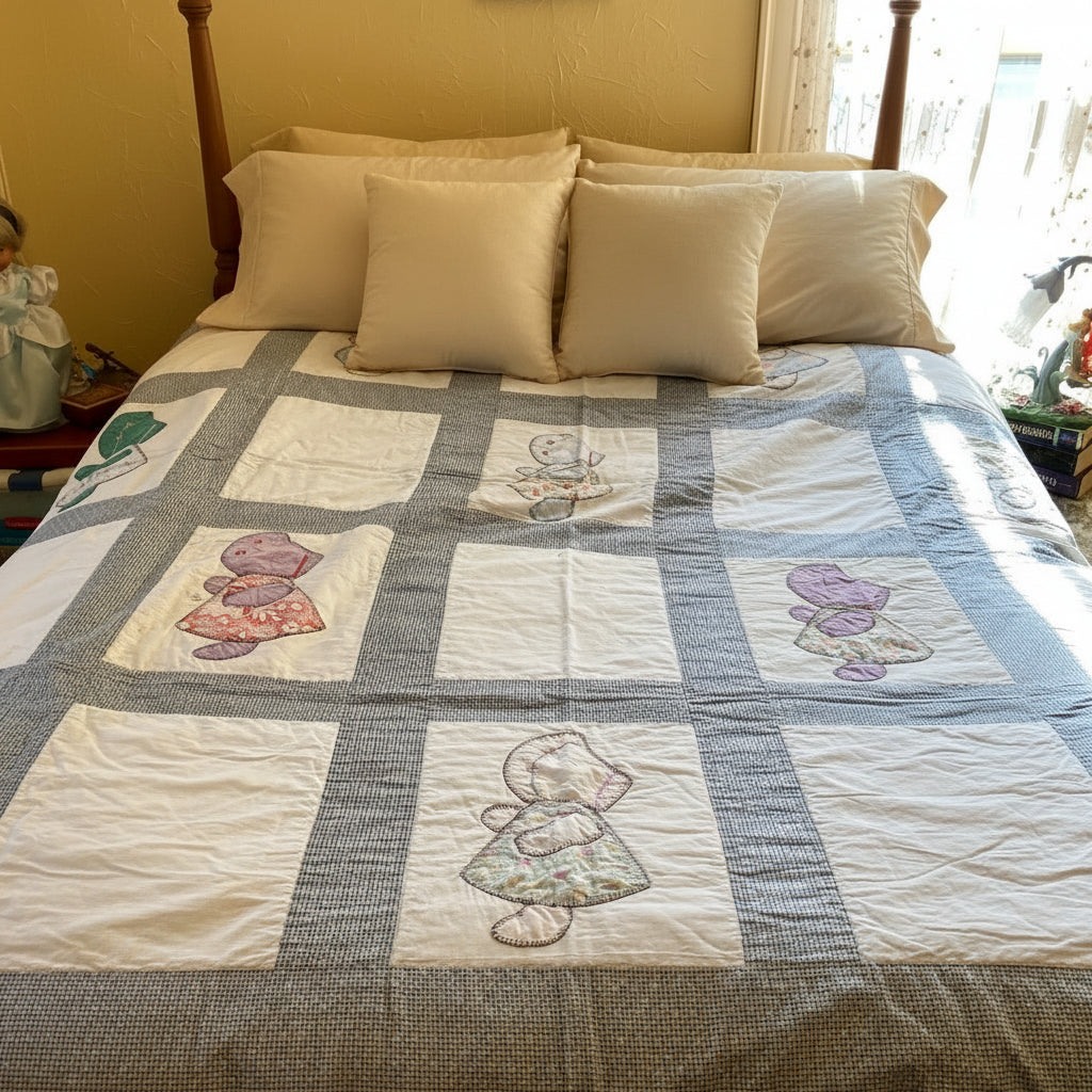 Quilt with Sun Bonnet Sue embroidered on squares on a bed in a room. 